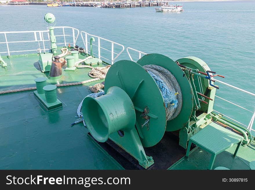 Winch with rope on ferry dropping anchor forward mooring station. Winch with rope on ferry dropping anchor forward mooring station