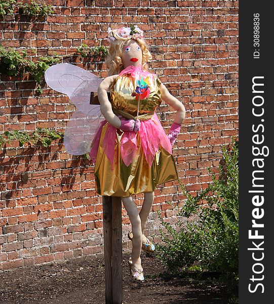 A Brightly Coloured Fairy Scarecrow in a Garden. A Brightly Coloured Fairy Scarecrow in a Garden.