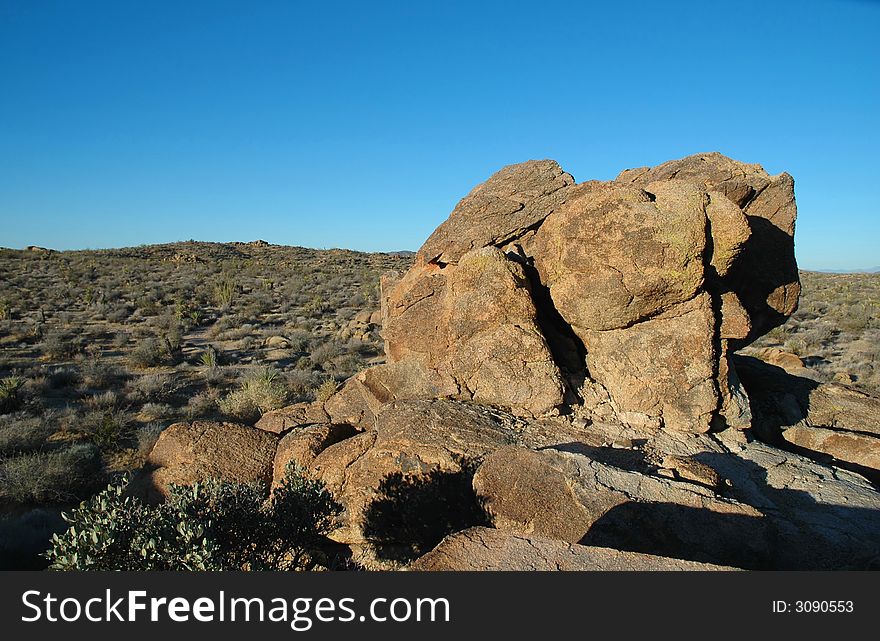 A landscape image from Joshua Tree National Park featuring large boulders and desert.