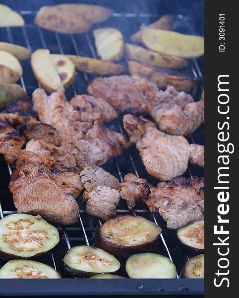 Delicious barbecue grilled meat, potatoes and eggplants