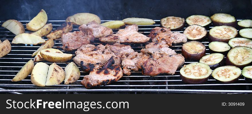 All kinds of delicious food items grilled on BBQ grill outdoors at picnic. All kinds of delicious food items grilled on BBQ grill outdoors at picnic