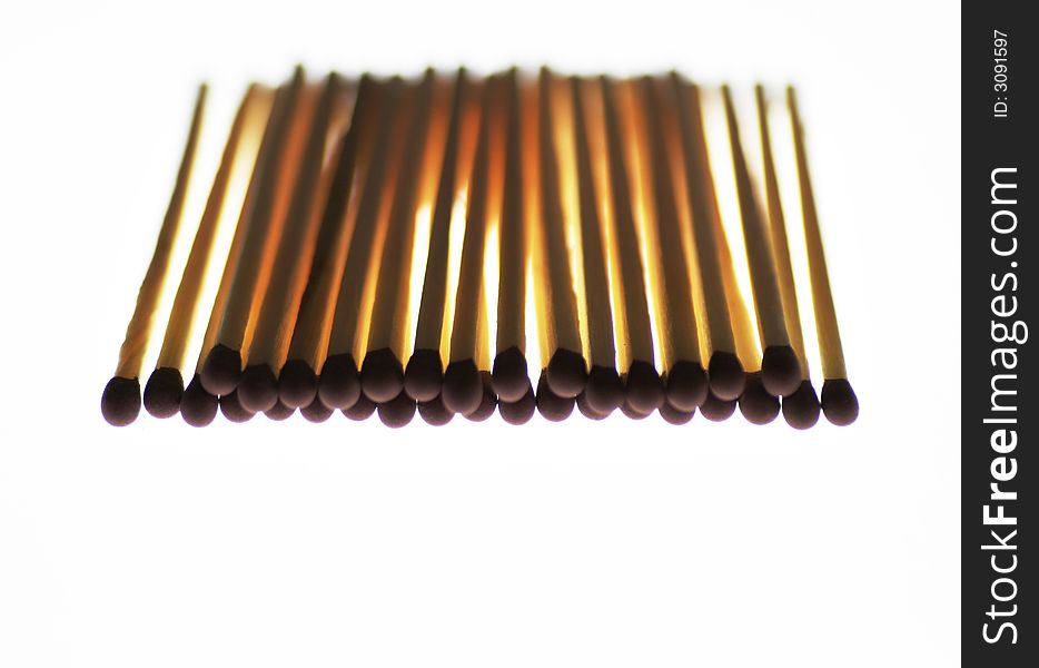 Many Wooden Matchsticks, Red Heads, White Background, Backlit, Shallow Depth Of Field. Many Wooden Matchsticks, Red Heads, White Background, Backlit, Shallow Depth Of Field