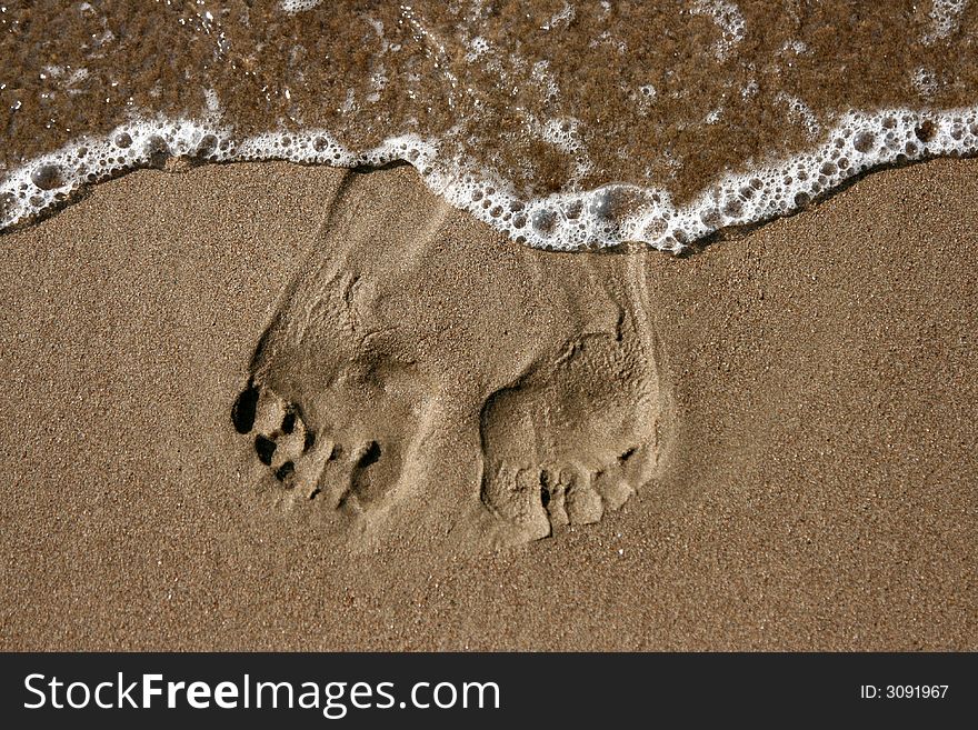 Traces of legs on sand, on seacoast