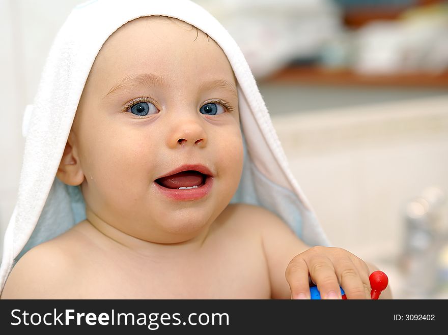 Baby under white towel