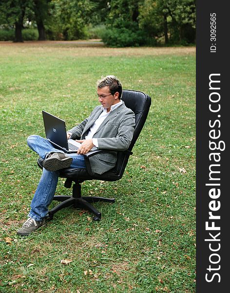 Man with a laptop working in a field