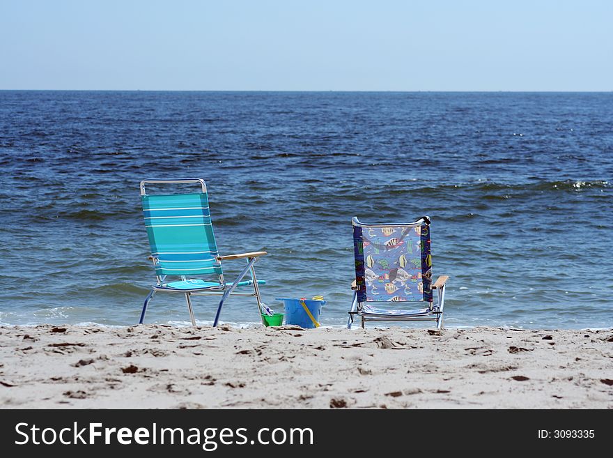 Beach Chairs near the ocean with bucket