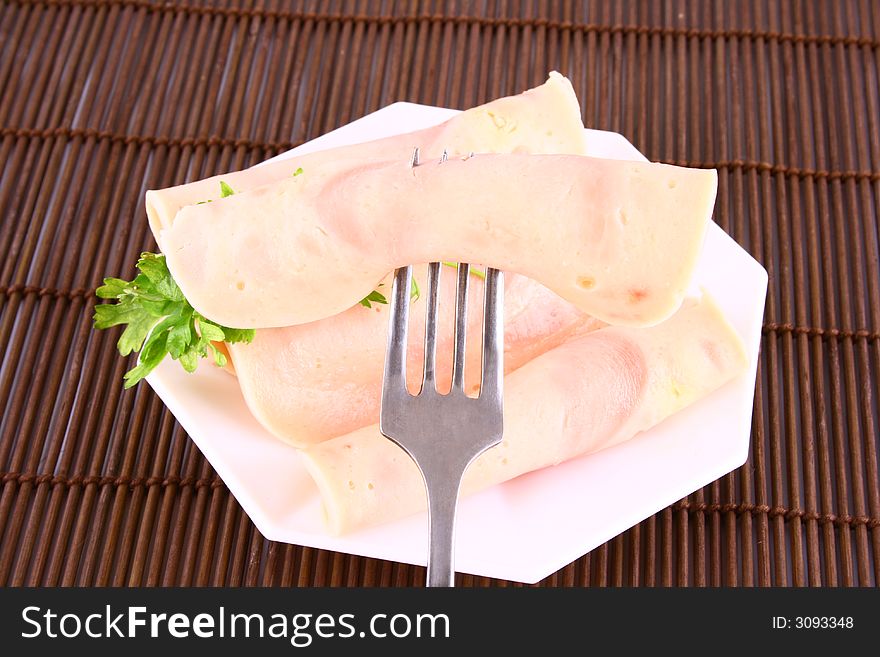 Ham slices on fork with top slice folded