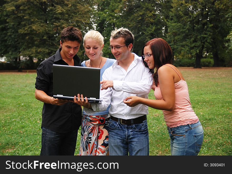 Group of people smiling and working in the field on the laptop