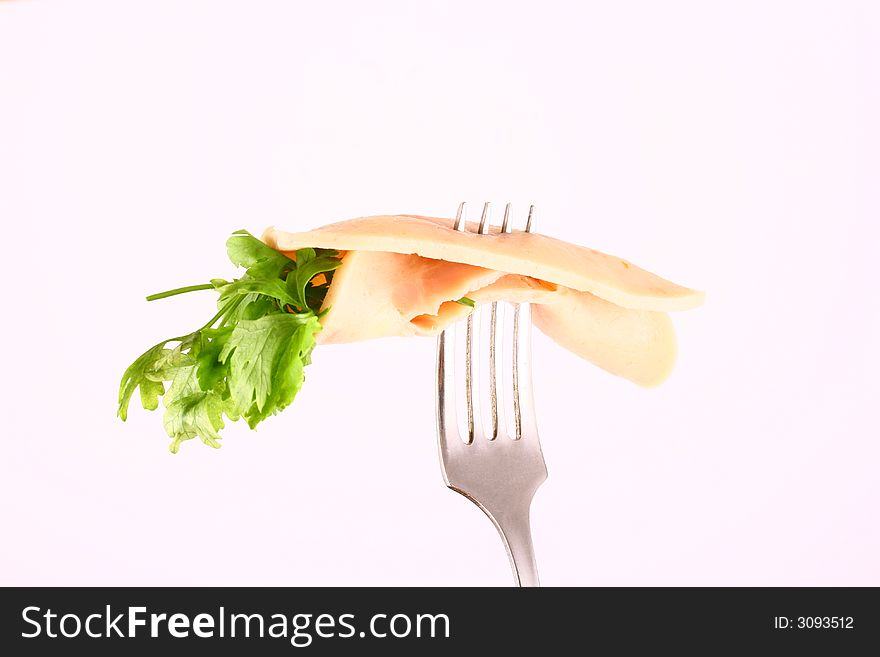 Ham slices on  fork with top slice folded