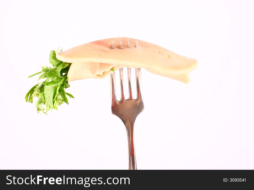 Ham slices on fork  with top slice folded
