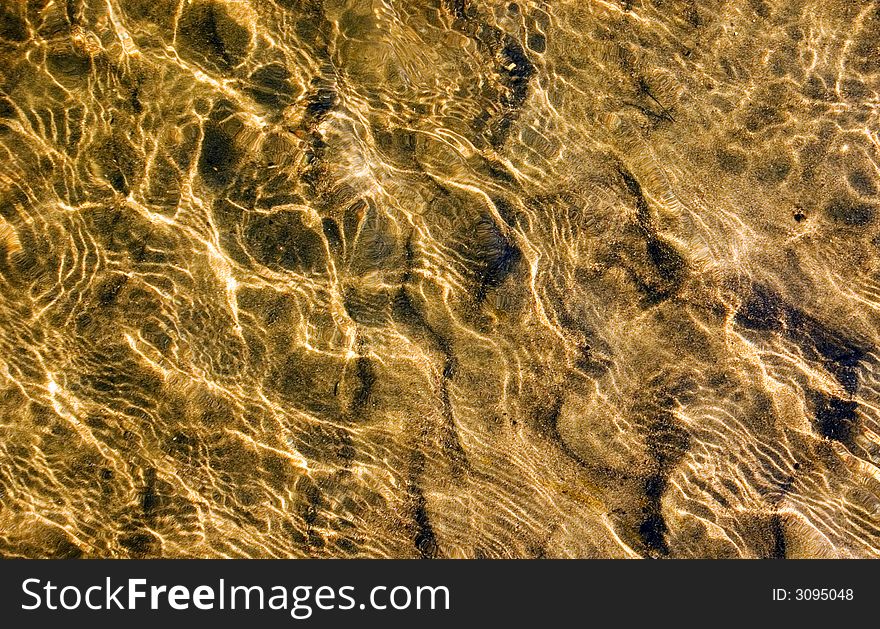 River bed with flowing water over it for background or texture. River bed with flowing water over it for background or texture