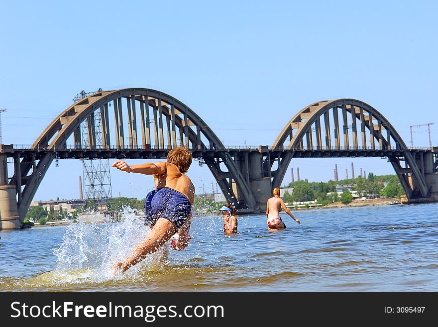 Boy Jumps After Ball In Water