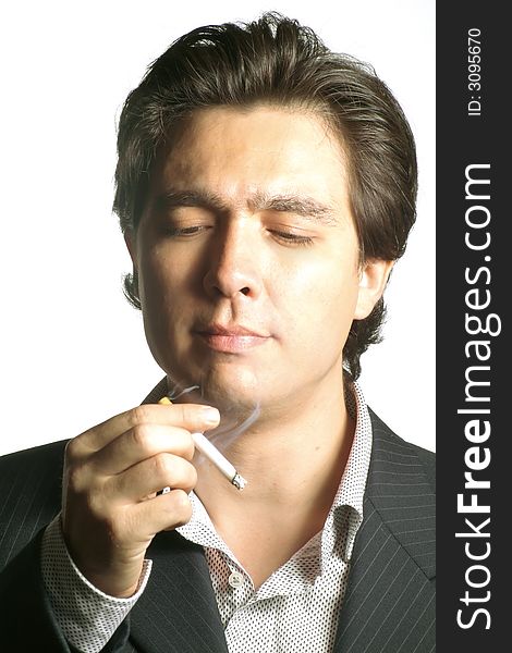 Young businessman sees his cigarette. Studio shot, isolated over white. Young businessman sees his cigarette. Studio shot, isolated over white.