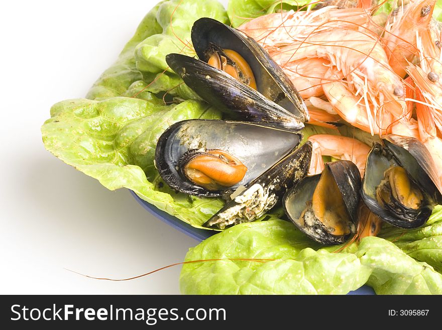 Fresh and delicious seafood meal: mussels, shrimps, seashells ( whelks)