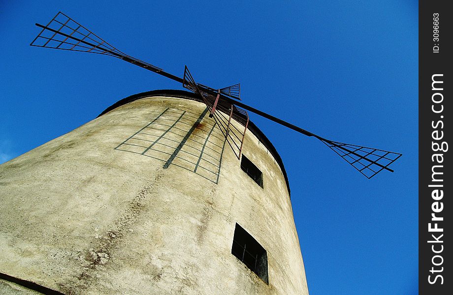 Old windmill on blue background