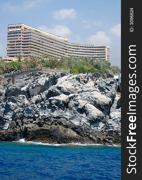 Hotel on the gray rock with the blue sky background. Hotel on the gray rock with the blue sky background