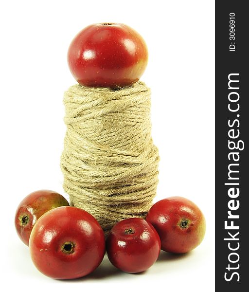 Composite: red apples and string on white background