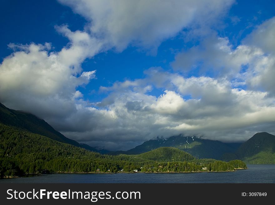 Blue sky and clouds over the coast of Sitka Alaska in the Inside Passage. Blue sky and clouds over the coast of Sitka Alaska in the Inside Passage