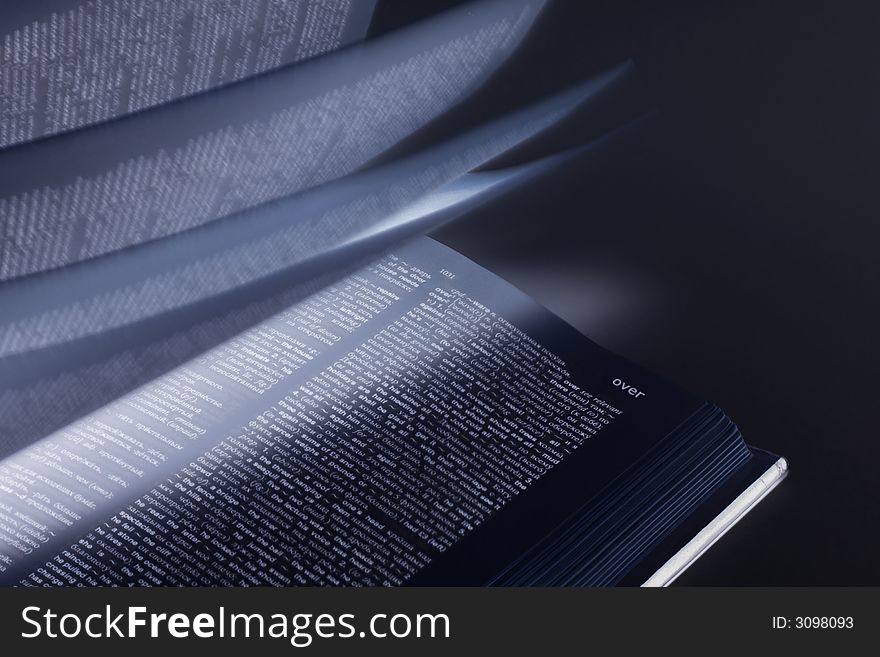 Word over on book with moving pages and mystical light