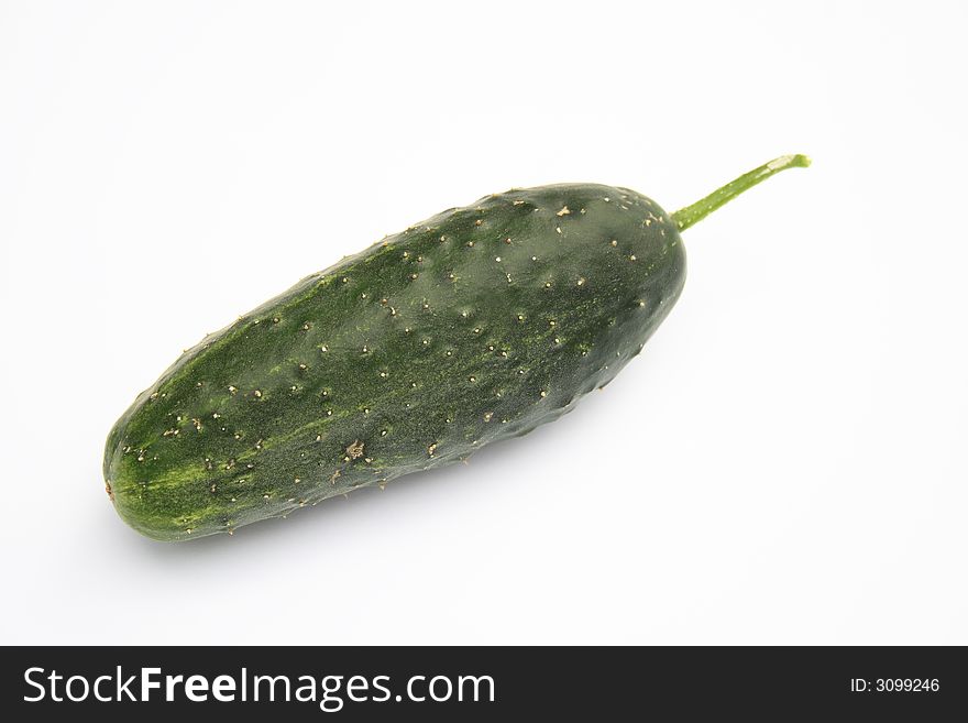 On a photo a green cucumber. The photo is isolated