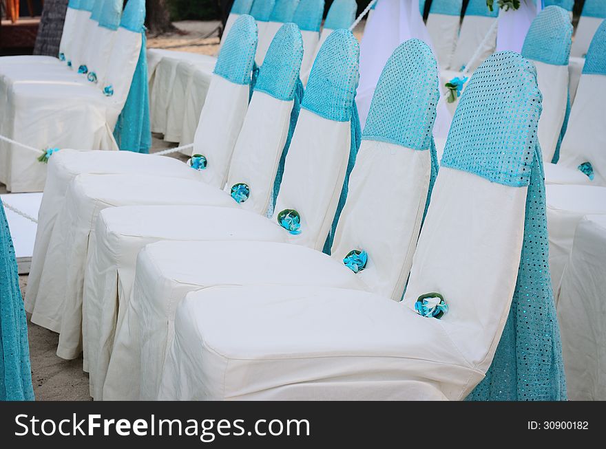 Closeup of wedding chair, decorated with blue ribbon. Closeup of wedding chair, decorated with blue ribbon.