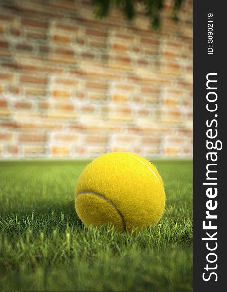 Yellow tennis ball on grass, with a brick wall in the background