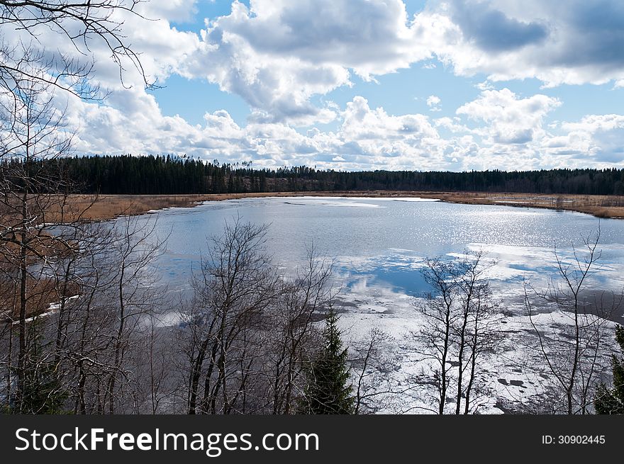 The afternoon sun reflecting from a lake with still some ice left in the spring thaw. The afternoon sun reflecting from a lake with still some ice left in the spring thaw.