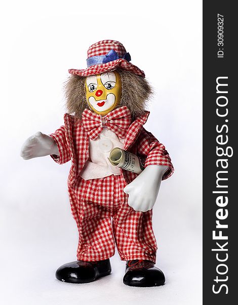 Toy clown with a dollar on a white background
