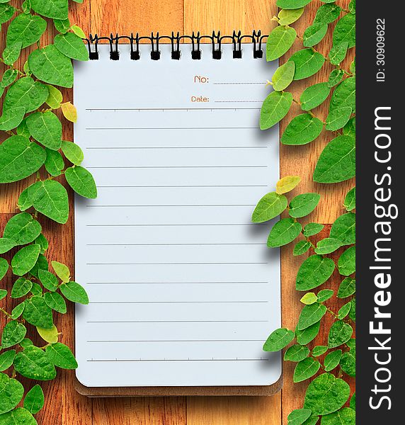 Blank Planning Notebook On Wood Background With Ivy Fixing Tree.