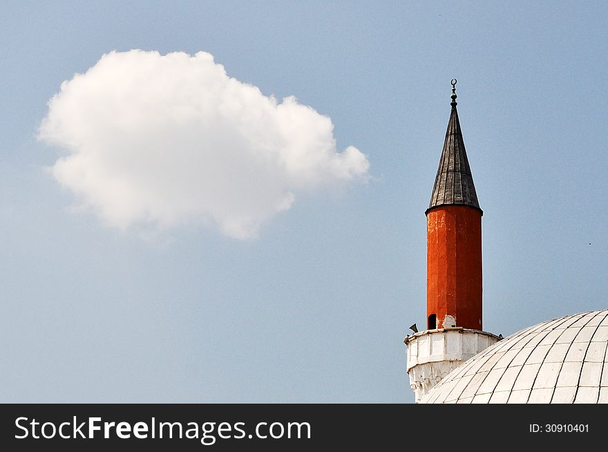 Minaret of a mosque with sky background