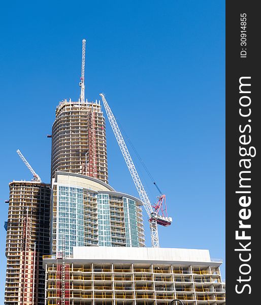 Condominium tower under construction with cranes. Condominium tower under construction with cranes