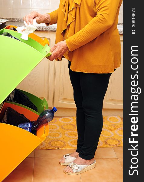 Woman doing waste sorting at home