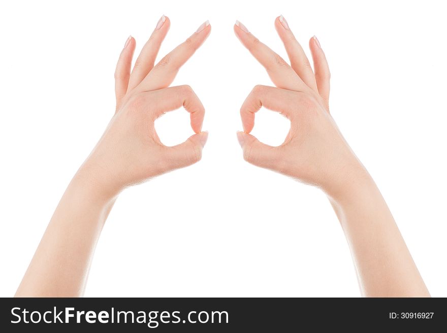 Woman's hands form the mask gesture on a white background. Woman's hands form the mask gesture on a white background.