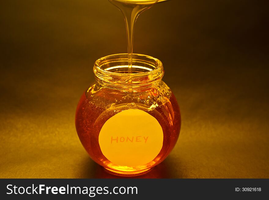 Honey being poured into the jar.