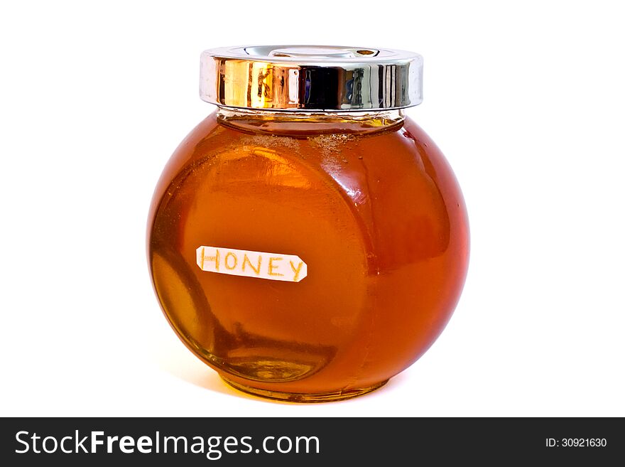 Bottle of pure honey isolated on white with clipping path.