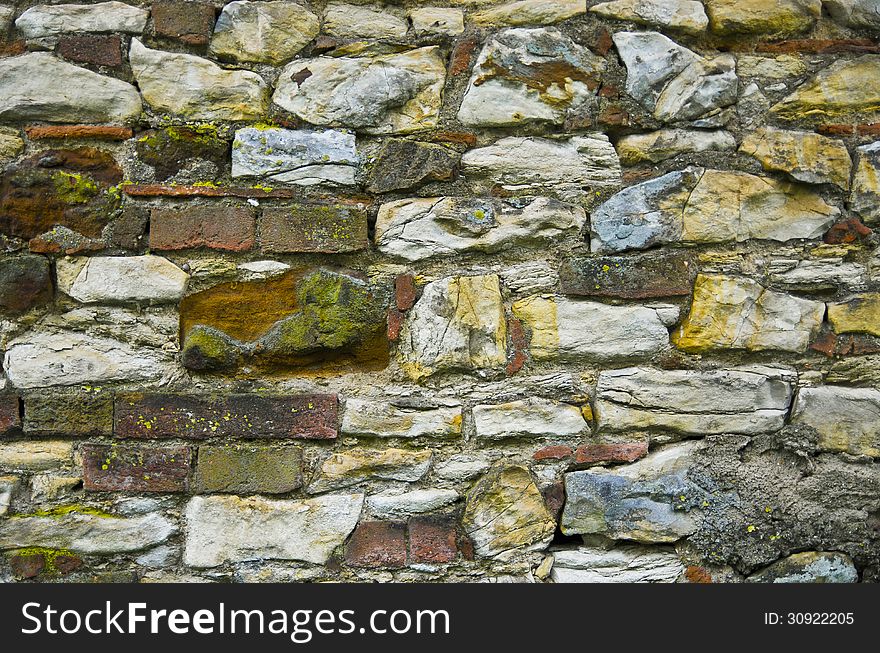 Natural wall full of many stones and bricks