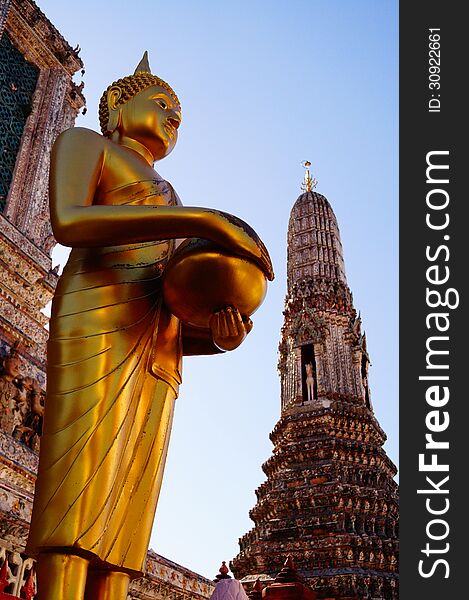 Buddha image in old temple in Bangkok with blue sky