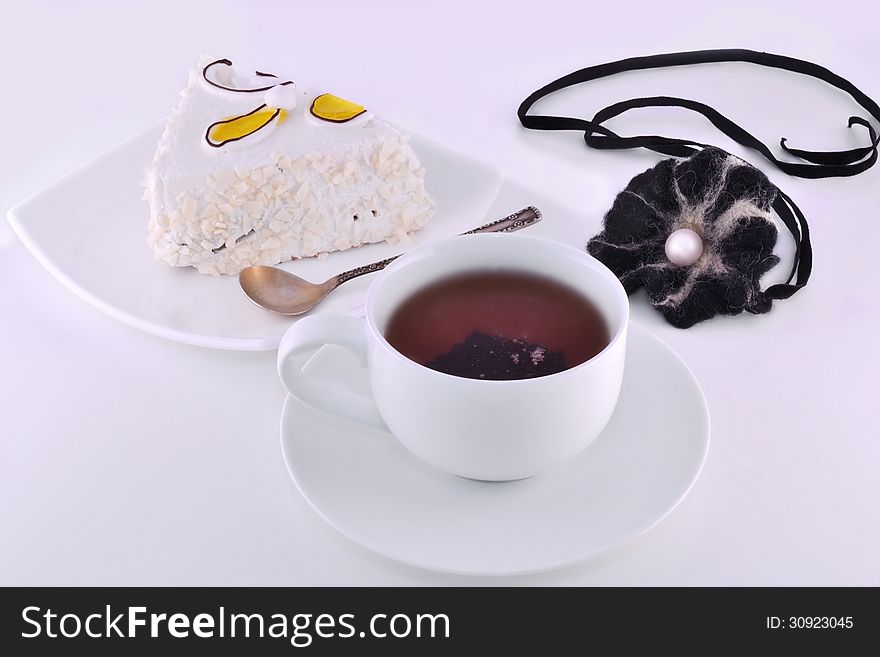 black tea and a slice of cake on a plate