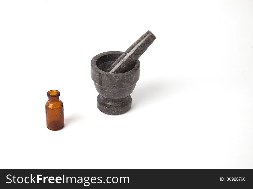 A mortar and pestle with an old medicine bottle.