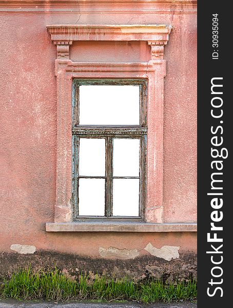 Old window frame on the wall with grass