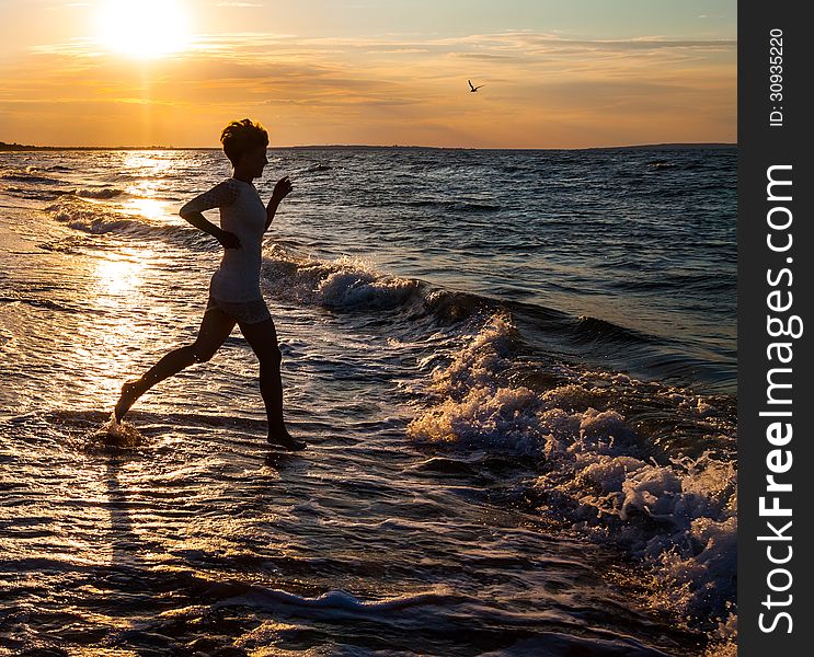 Silhouette of beautiful girl running on beach. Silhouette of beautiful girl running on beach