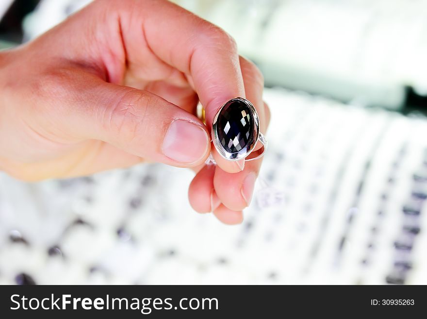 Woman hand holding a silver ring,black jasper. Woman hand holding a silver ring,black jasper