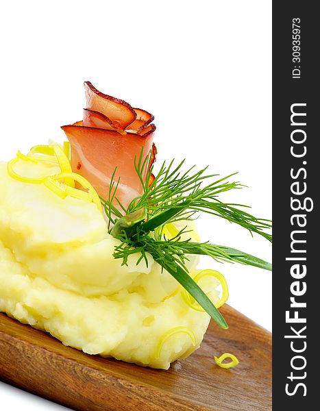 Snack of Rolled up Delicious Bacon with Mashed Potato, Dill, Spring Onion and Leek closeup on Wooden Plate. Snack of Rolled up Delicious Bacon with Mashed Potato, Dill, Spring Onion and Leek closeup on Wooden Plate