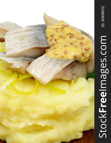 Delicious Piquant Herring on Mashed Potato and Mustard closeup. Delicious Piquant Herring on Mashed Potato and Mustard closeup