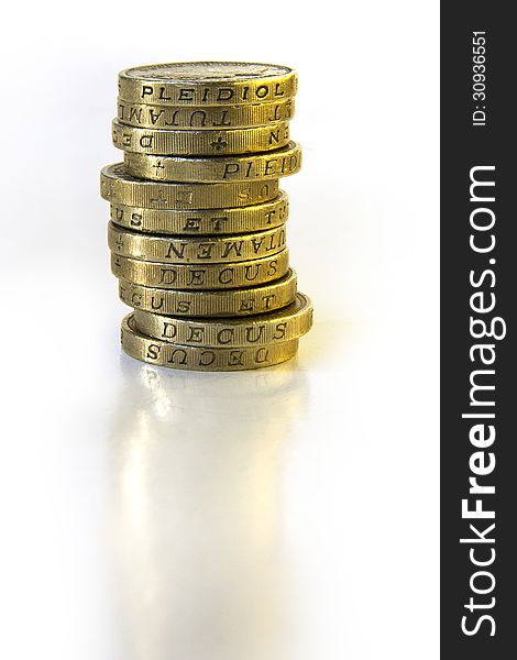 Stack of British One Pound coins with subtle reflection. Stack of British One Pound coins with subtle reflection