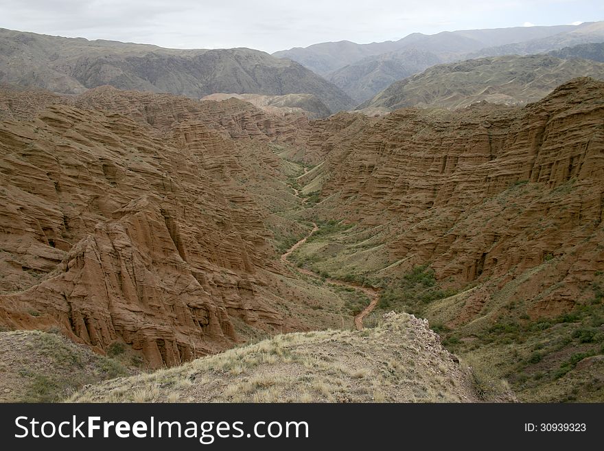 Red canyon. Dry channel of the river on a background of red mountains.