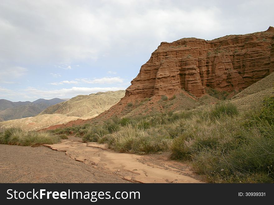 Dry channel of the river on a background of red mountains. Dry channel of the river on a background of red mountains.