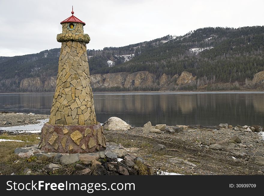 Beacon at coast. Lighthouse at River landscape. Beacon at coast. Lighthouse at River landscape.