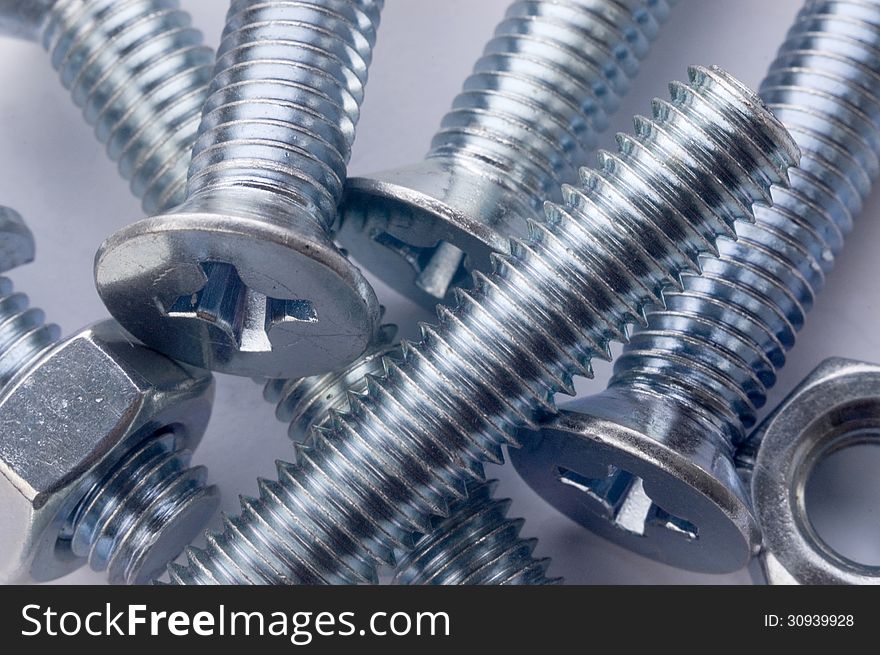 The large bolts and screws on a white background. The large bolts and screws on a white background.