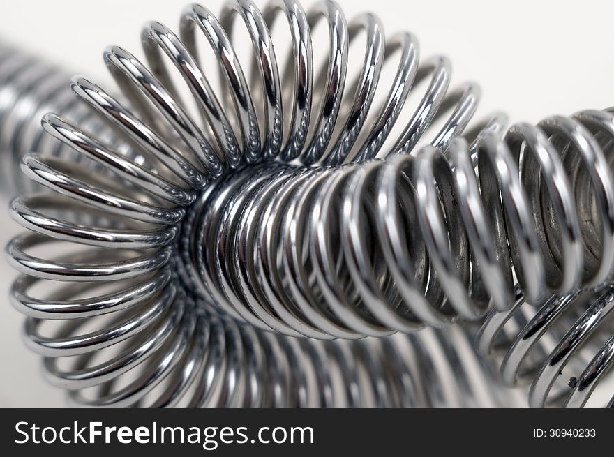 Steel spiral fastened in unit on a white background. Steel spiral fastened in unit on a white background.